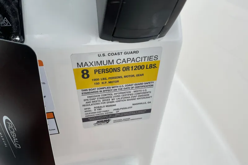 Slide: The Image of Robalo R180 Center Console 2026 capacity label, 8 persons or 1200 lbs, U.S. Coast Guard compliant. - 19