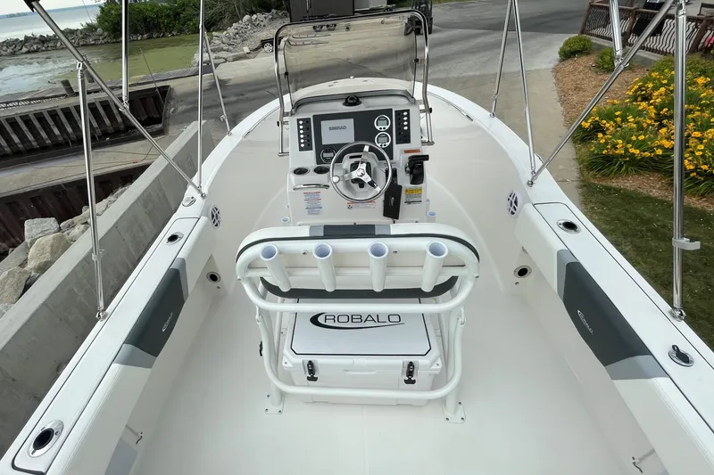 Slide: The Image of 2026 Robalo R180 Center Console boat interior with steering wheel and rod holders. - 20