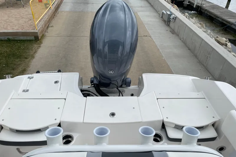 Slide: The Image of 2026 Robalo R180 Center Console boat with outboard motor at dockside. - 21