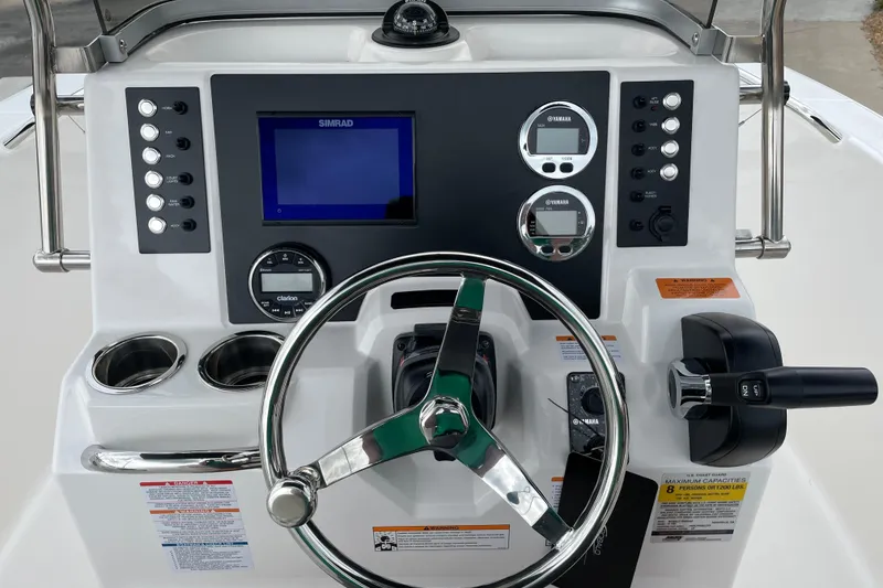 Slide: The Image of 2026 Robalo R180 Center Console dashboard with steering wheel, controls, and navigation display. - 25