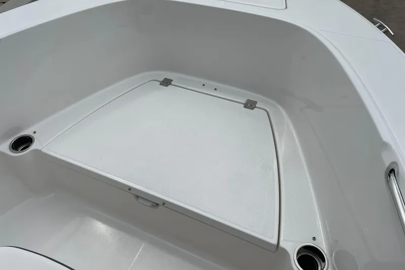 Slide: The Image of 2026 Robalo R180 Center Console boat interior with storage compartment and cup holders. - 31