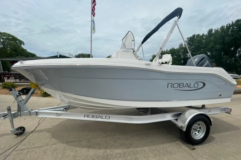 Slide: The Image of 2026 Robalo R180 Center Console boat on trailer, displayed outdoors. - 4