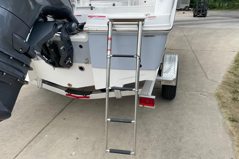 Slide: The Image of 2026 Robalo R180 Center Console boat with ladder and outboard motor on trailer. - 9