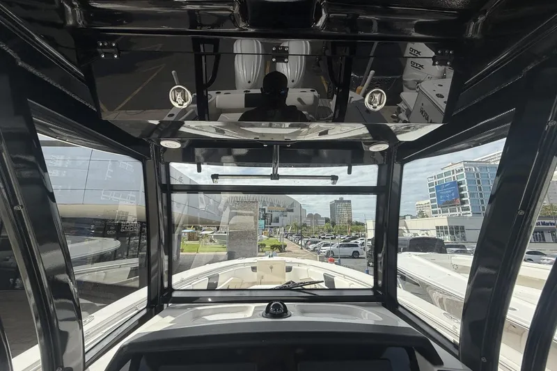 Slide: The Image of 2023 Robalo R302 Center Console boat interior with cityscape view through windows. - 5