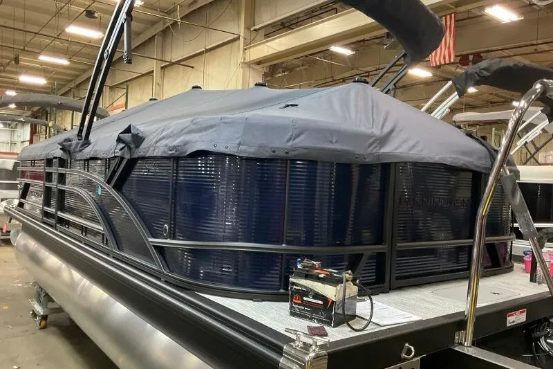 Slide: The Image of 2026 Bennington 22 SSRSF pontoon boat in a showroom, featuring sleek design and modern amenities. - 10
