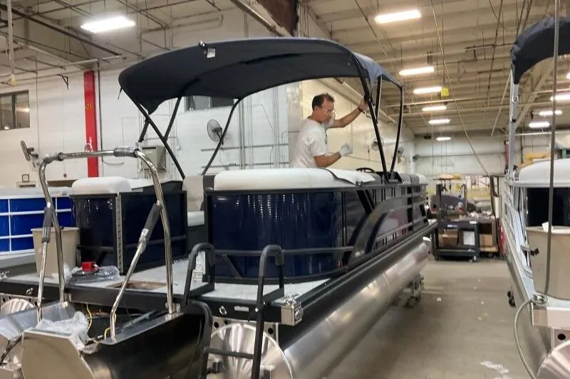 Slide: The Image of 2026 Bennington 22 SSRSF pontoon boat in a showroom, showcasing sleek design and modern features. - 7