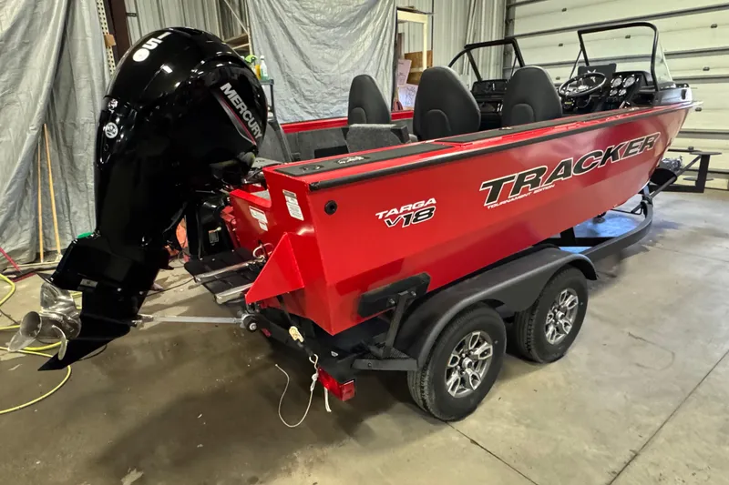 Slide: The Image of 2026 Tracker Targa V-18 Combo boat with Mercury engine in a garage setting. - 3