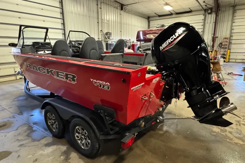 Slide: The Image of 2026 Tracker Targa V-18 Combo boat with Mercury engine in a garage setting. - 4