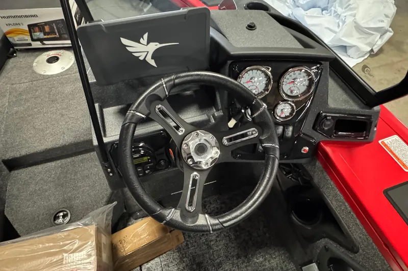 Slide: The Image of 2026 Tracker Targa V-18 Combo boat dashboard with steering wheel and gauges. - 7