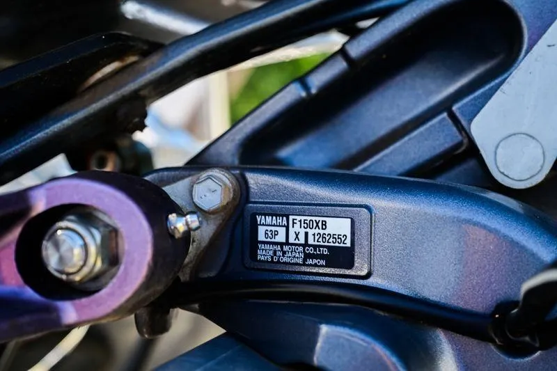 Slide: The Image of Close-up of Yamaha F150XB engine part on 2023 Aloha Pontoon 260 Tropical Series Sundeck. - 14