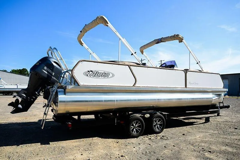 Slide: The Image of 2023 Aloha Pontoon Mahalo 23 boat with Yamaha engine on trailer. - 2