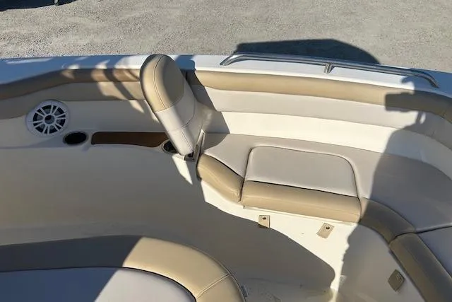 Slide: The Image of 2022 Scout 215 XSF boat interior with beige seating and speaker. - 19
