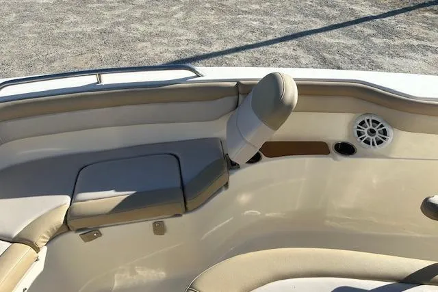 Slide: The Image of 2022 Scout 215 XSF boat interior with beige seating and speaker. - 20