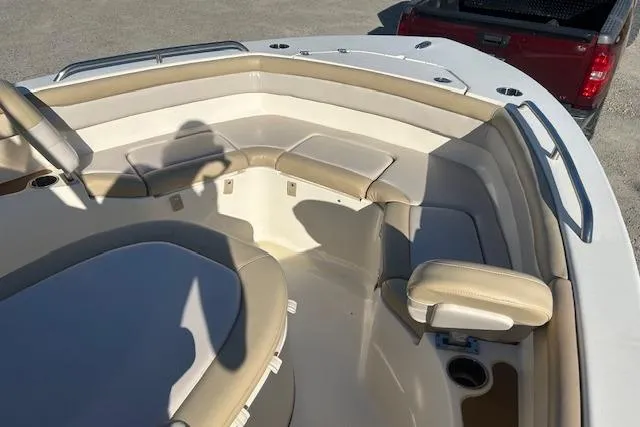 Slide: The Image of 2022 Scout 215 XSF boat interior with beige seating and cup holder. - 21
