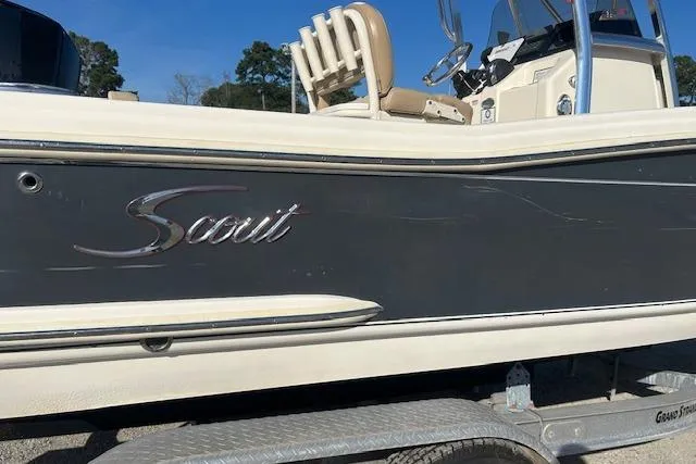 Slide: The Image of 2022 Scout 215 XSF boat on trailer, side view with logo visible. - 3