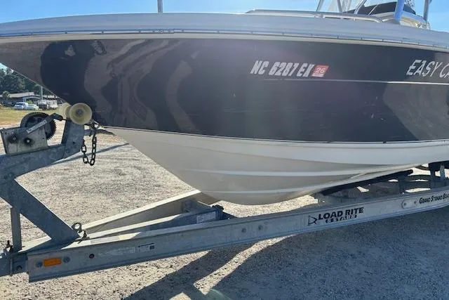 Slide: The Image of 2022 Scout 215 XSF boat on Load Rite trailer, parked outdoors. - 4