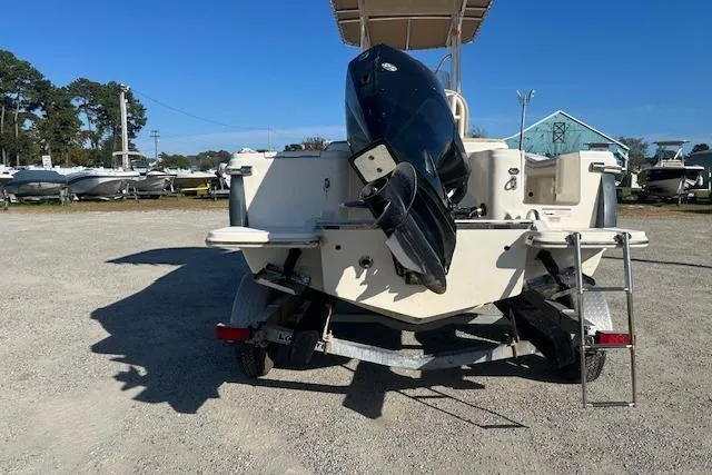 Slide: The Image of 2022 Scout 215 XSF boat on trailer, rear view with outboard motor. - 6