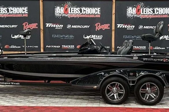 The Image of 2023 Ranger Z520R boat displayed at Angler's Choice event with branded backdrop. - 1