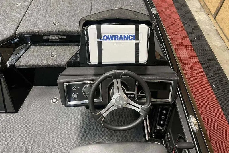 Slide: The Image of 2023 Ranger Z520R boat dashboard with steering wheel and Lowrance display. - 6
