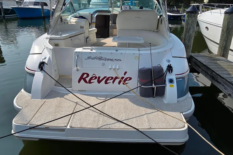 Slide: The Image of 2005 Cruisers Yachts 340 Express docked, featuring spacious deck and elegant design. - 2