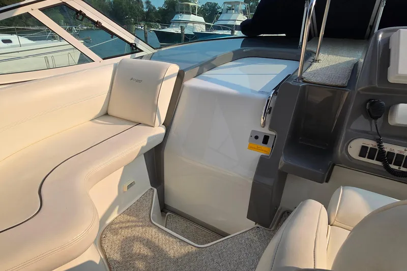 Slide: The Image of 2005 Cruisers Yachts 340 Express interior with beige seating and control panel. - 9