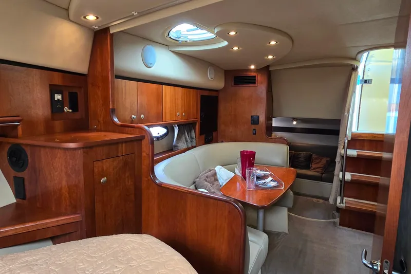Slide: The Image of Luxurious 2005 Cruisers Yachts 340 Express cabin interior with wood finish and cozy seating area. - 15
