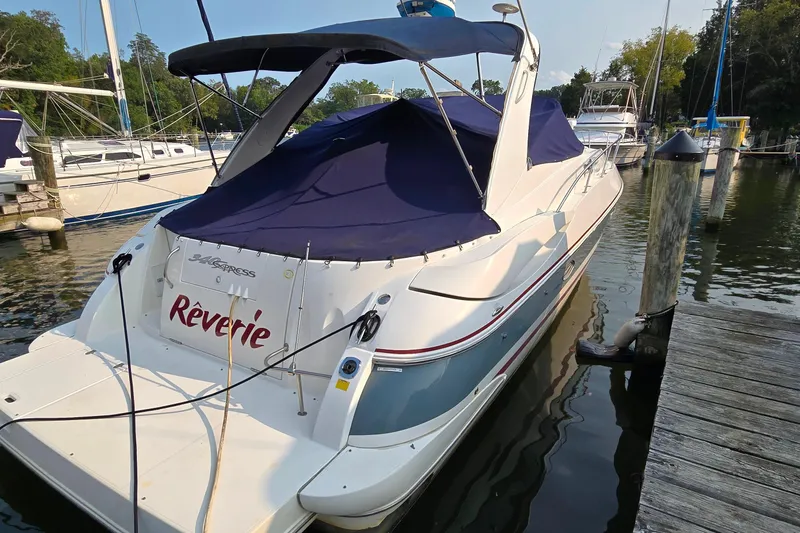 Slide: The Image of 2005 Cruisers Yachts 340 Express docked, covered in navy blue canvas. - 5