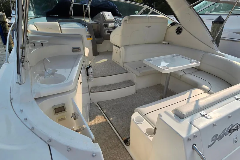 Slide: The Image of 2005 Cruisers Yachts 340 Express interior with seating, table, and sink. - 6