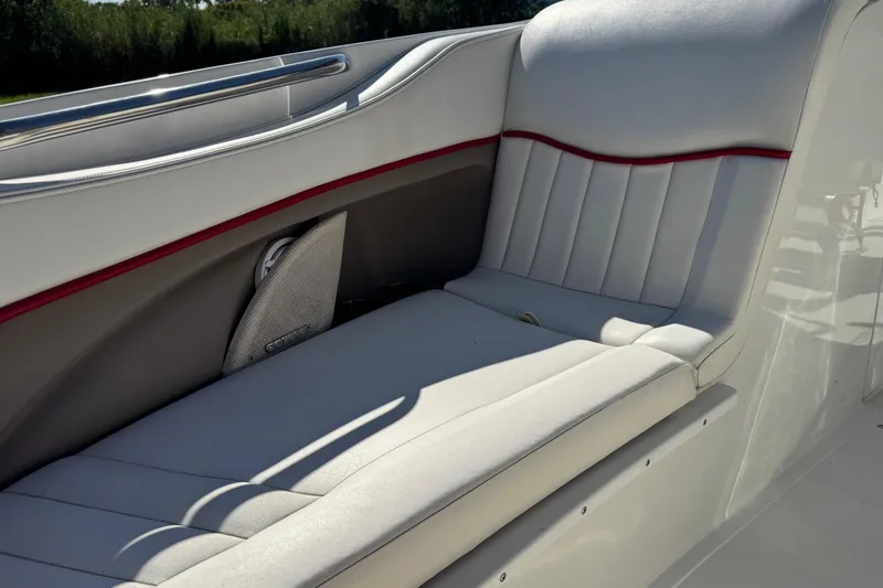Slide: The Image of 2003 Cobalt 282 boat interior with white and red-trimmed seating. - 10