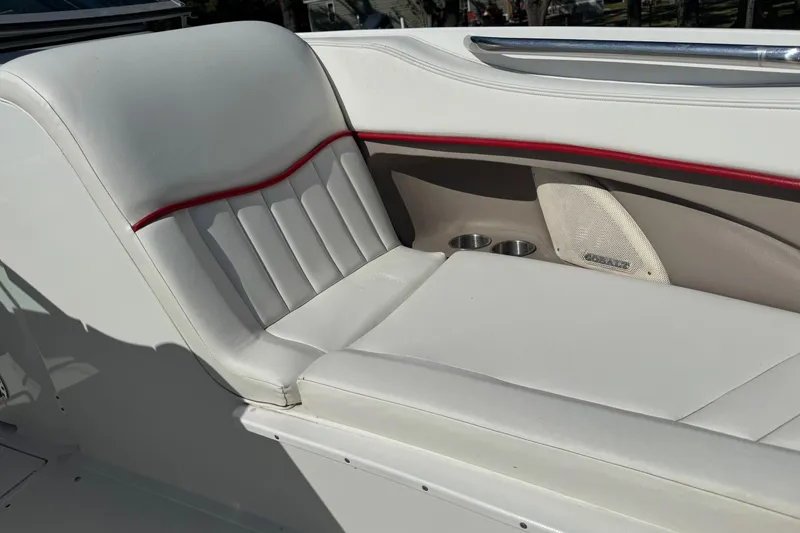 Slide: The Image of 2003 Cobalt 282 boat interior with white seating and red trim accents. - 11