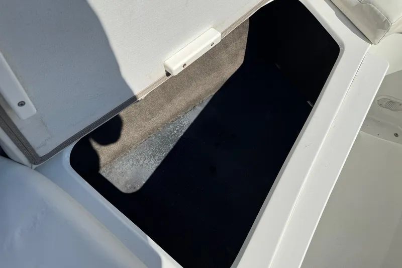 Slide: The Image of Open storage compartment on a 2003 Cobalt 282 boat, showing interior space. - 12