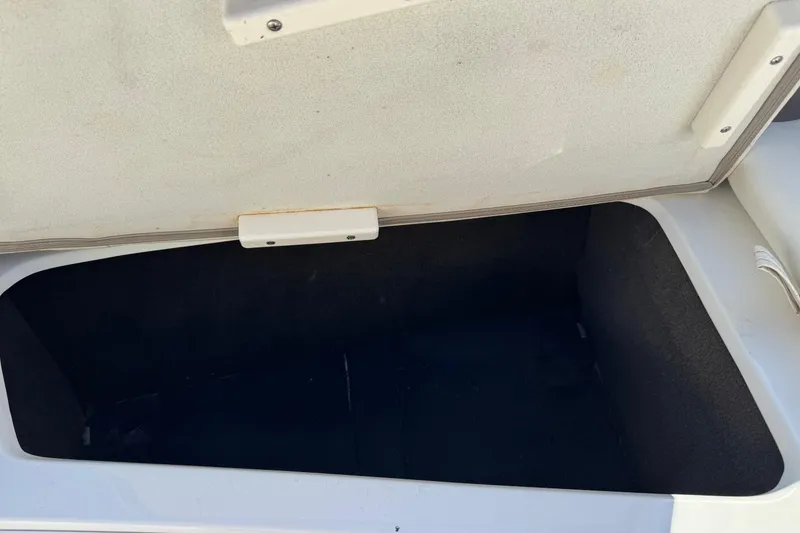 Slide: The Image of Open storage compartment in a 2003 Cobalt 282 boat. - 13