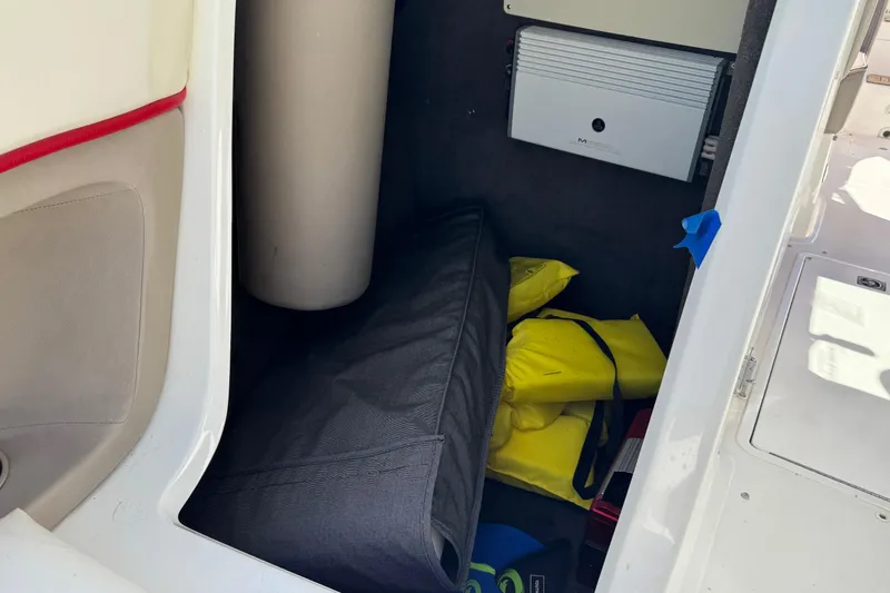 Slide: The Image of Storage compartment in a 2003 Cobalt 282 boat with life jackets and equipment. - 14