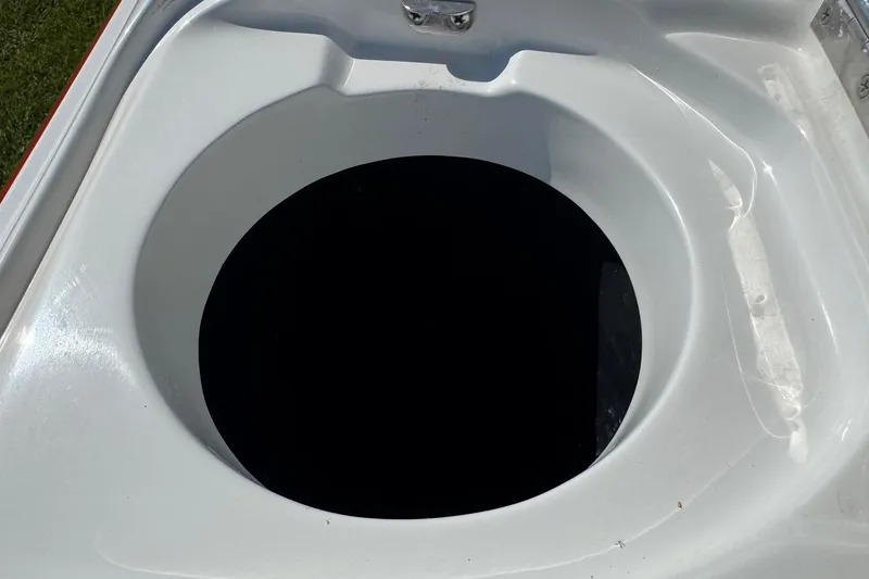 Slide: The Image of Circular storage compartment on a 2003 Cobalt 282 boat. - 17