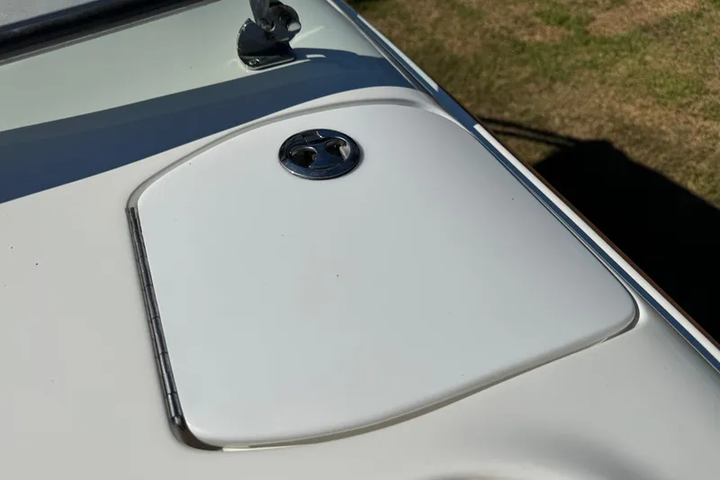 Slide: The Image of Hatch cover on 2003 Cobalt 282 boat, featuring a sleek design and chrome details. - 19