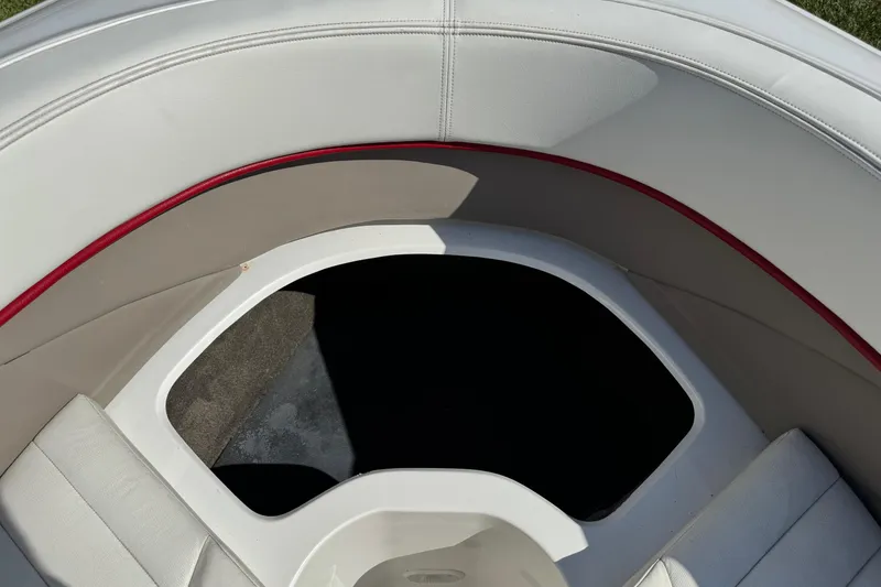 Slide: The Image of 2003 Cobalt 282 boat interior with white and red seating, open storage area. - 20