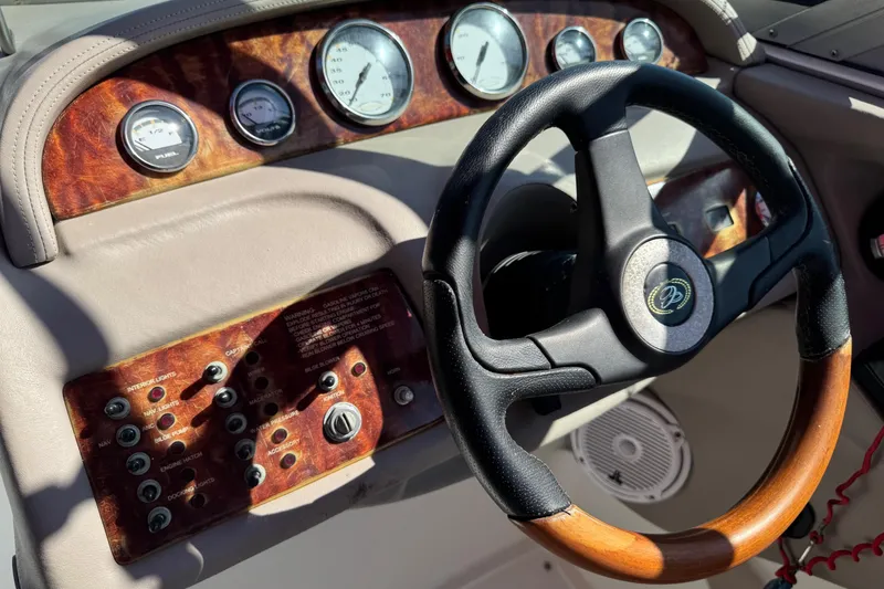 Slide: The Image of Dashboard of a 2003 Cobalt 282 boat with gauges and steering wheel. - 21