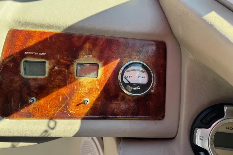 Slide: The Image of Dashboard of a 2003 Cobalt 282 boat with air/water temperature and depth gauges. - 22