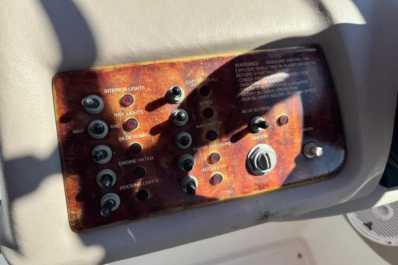 Slide: The Image of Control panel of a 2003 Cobalt 282 boat with various switches and ignition. - 23