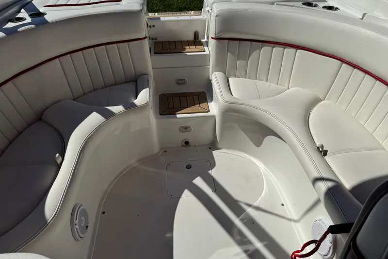 Slide: The Image of Interior of a 2003 Cobalt 282 boat with white leather seating and red accents. - 27