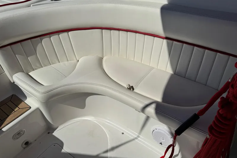 Slide: The Image of 2003 Cobalt 282 boat interior with white and red cushioned seating. - 29