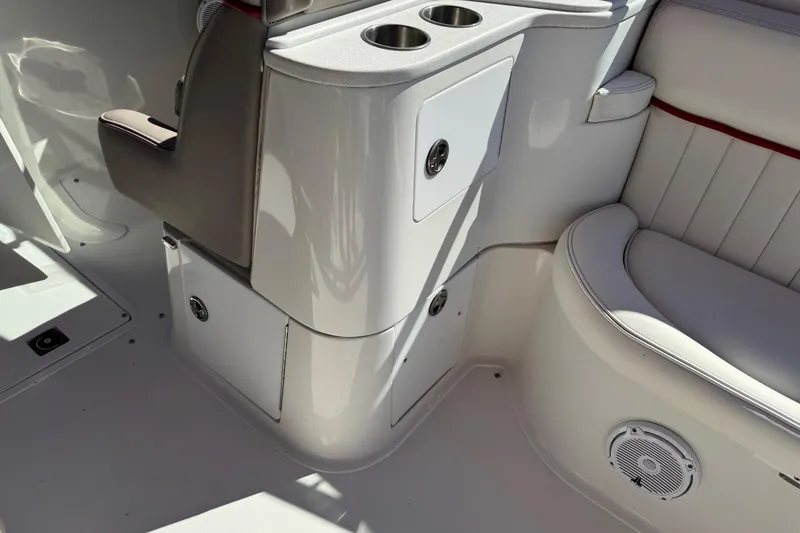 Slide: The Image of Interior of a 2003 Cobalt 282 boat featuring seating and cup holders. - 31