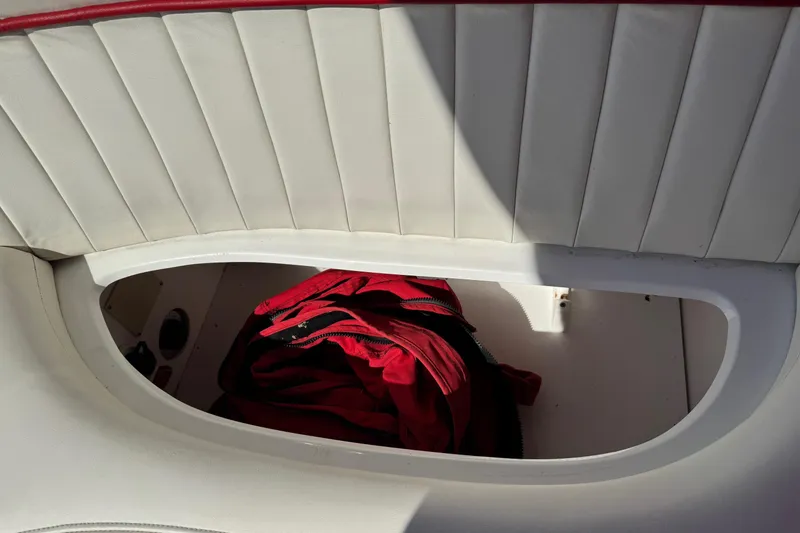 Slide: The Image of Storage compartment in 2003 Cobalt 282 boat with red bag inside. - 32