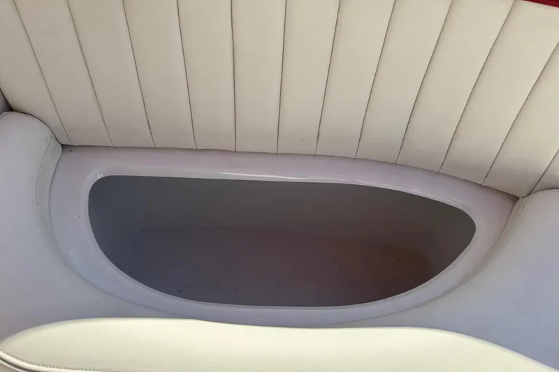 Slide: The Image of 2003 Cobalt 282 boat interior storage compartment with white upholstery. - 33
