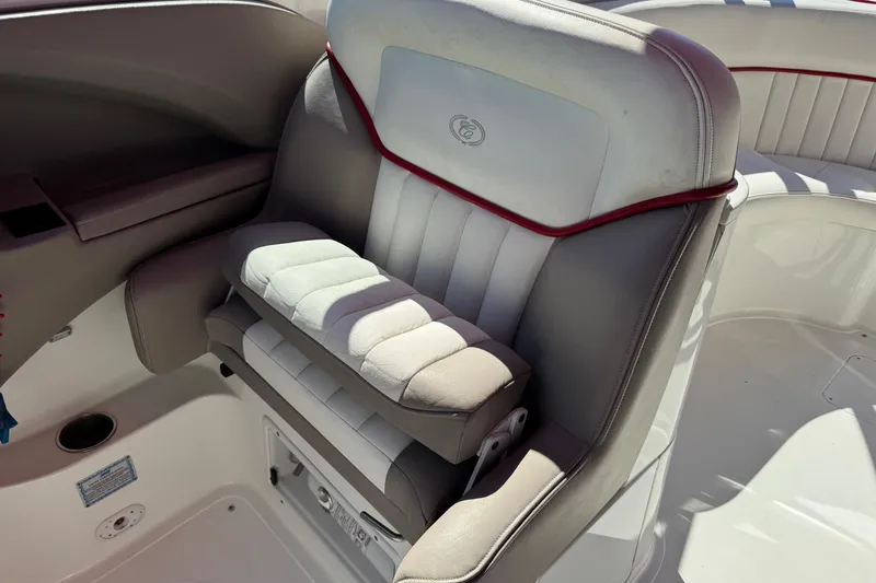 Slide: The Image of 2003 Cobalt 282 boat interior with cushioned seating and red accents. - 35