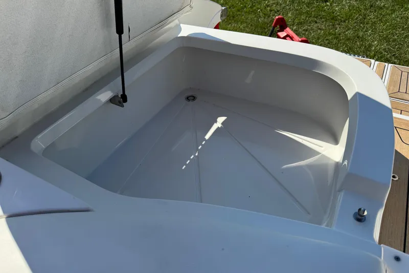 Slide: The Image of Open storage compartment on 2003 Cobalt 282 boat, featuring clean white interior. - 38