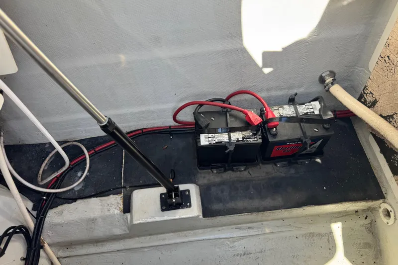 Slide: The Image of Battery compartment of a 2003 Cobalt 282 boat with wiring and hydraulic support. - 5