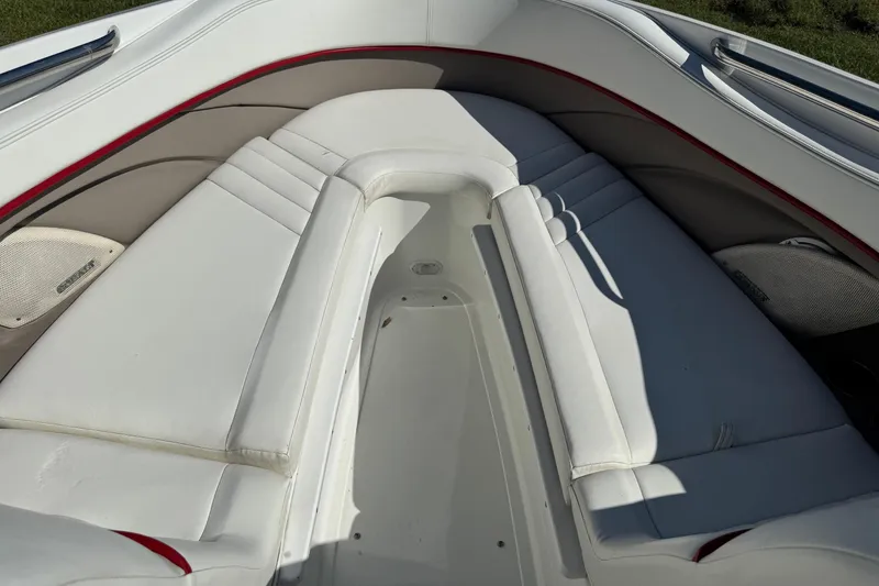 Slide: The Image of 2003 Cobalt 282 boat interior with white cushioned seating and red accents. - 7
