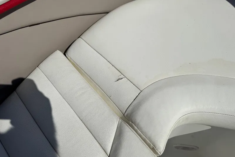 Slide: The Image of Torn white upholstery on 2003 Cobalt 282 boat seat. - 8