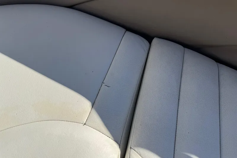 Slide: The Image of White leather boat seat with slight wear, Cobalt 282, 2003 model. - 9